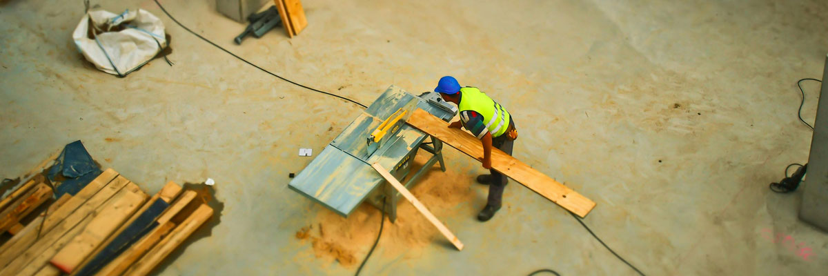 birds-eye view a man using a table saw on a construction site